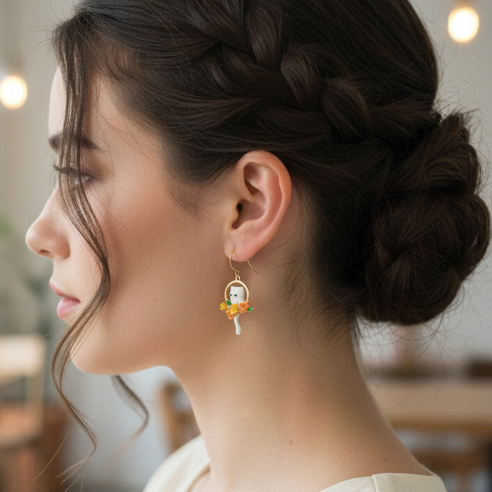 Handcrafted gold-plated cat earrings shown on model