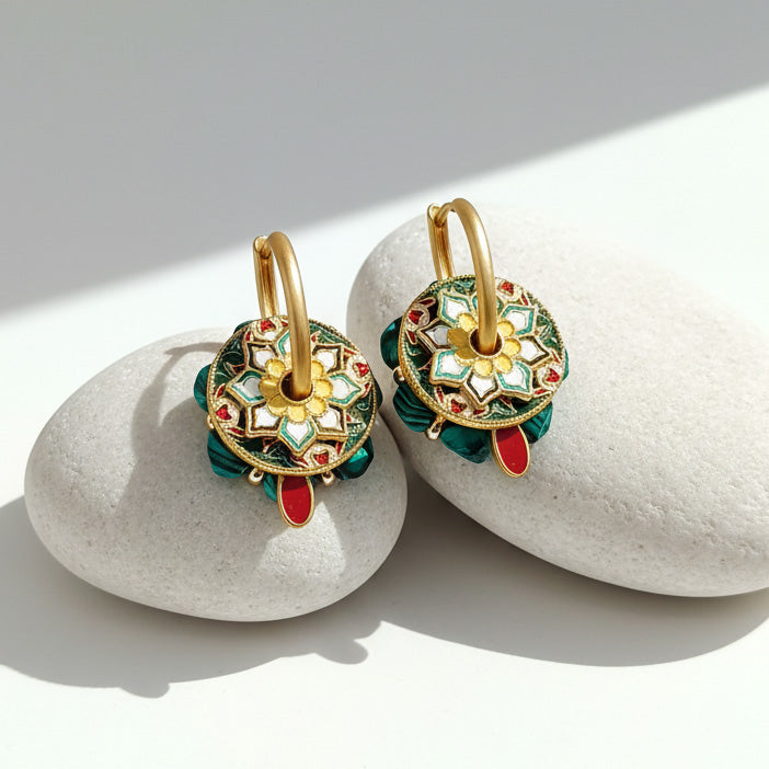 Convertible cloisonné malachite hoop earrings worn as statement drop earrings on stone surface