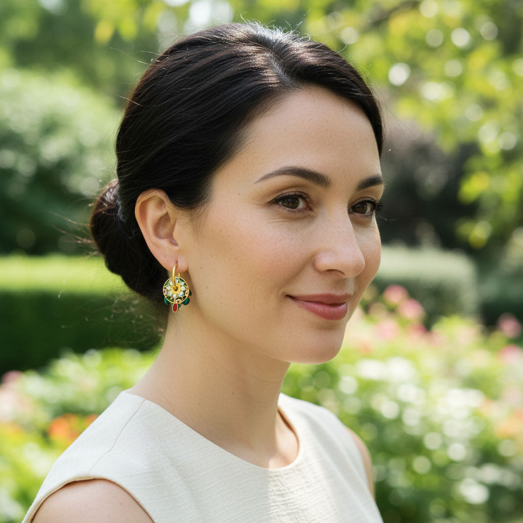 Woman with a bun hairstyle wearing earrings in a garden setting