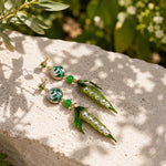 Woman wearing Pea Pod & Baroque Pearl Drop Earrings with hand-painted enamel pea pods, glass pearls, hand-painted baroque pearls, jade beads and sparkling CZ studs.