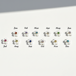 White flower charms with 12 colourful birthstone centres representing each month from January to December.