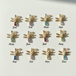  twelve dragonfly-shaped earrings with colored gemstones on a white background