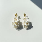 Pair of floral earrings on a light gray background