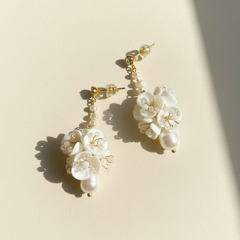 Porcelain flower drop earrings with freshwater pearls and gold-plated finish.