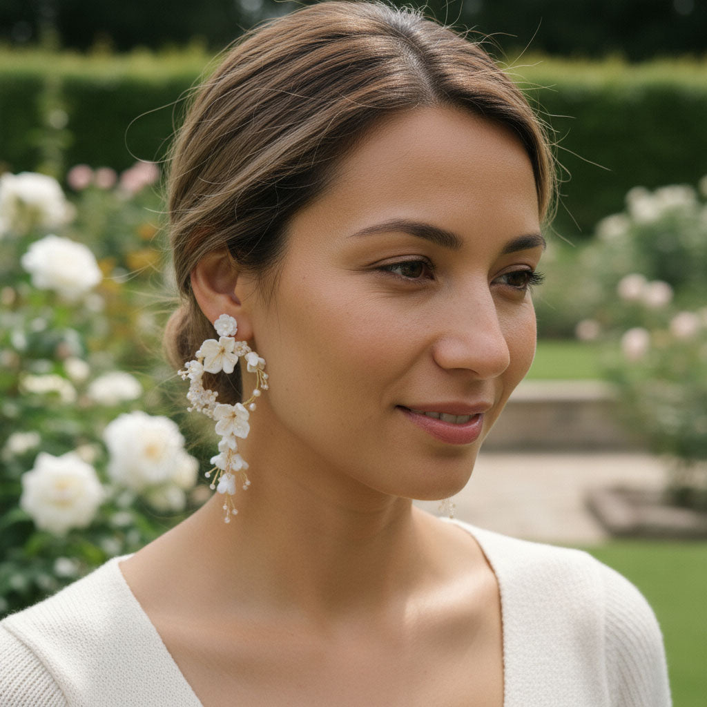 Woman wearing floral earrings in a garden setting