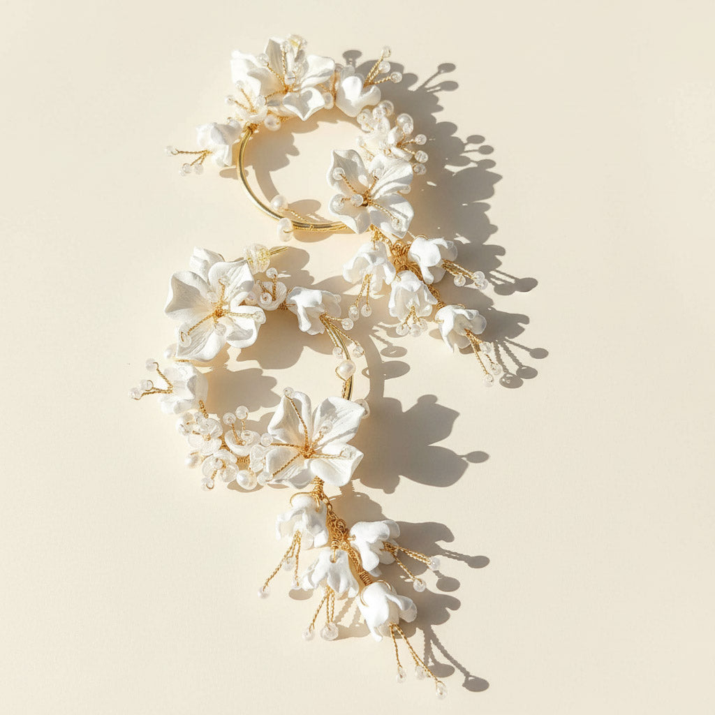 Floral headpiece with white flowers and gold accents on a beige background