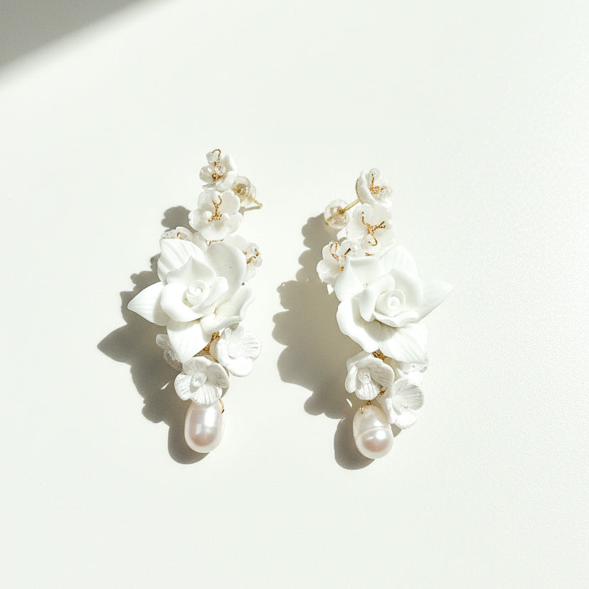 White porcelain bridal earrings with cascading pearls and floral design
