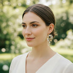 Woman wearing a white top with a blurred green background