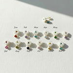 Mother-of-pearl flower stud earrings with 12 birthstone colors labeled by month from January to December