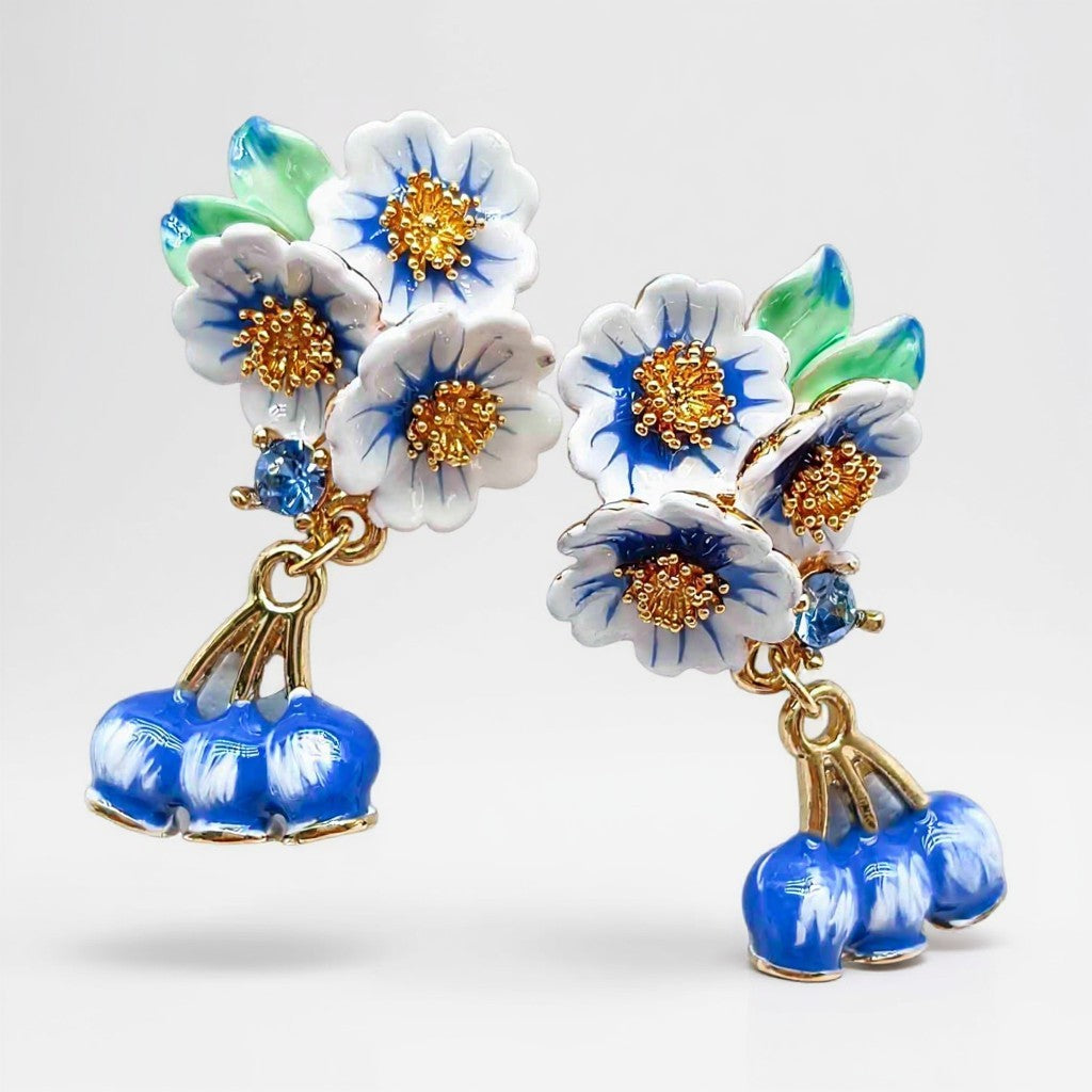 Floral earrings with blue and gold accents on a white background