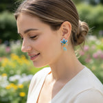 Woman wearing floral earrings with a blurred natural background
