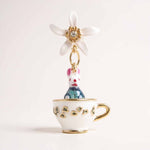 Teacup charm with a rabbit and flower on a white background