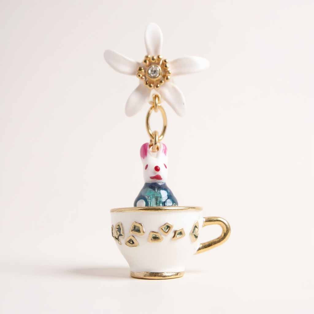 Teacup charm with a rabbit and flower on a white background