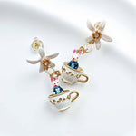 Earrings with teacup and rabbit design on a white background