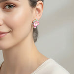 Close-up of a woman wearing a floral earring with a blurred background