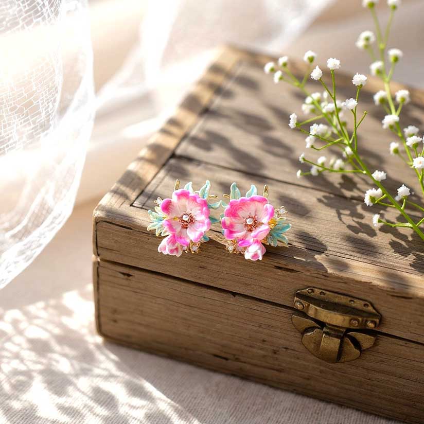 Floral earrings on a wooden box with a soft background