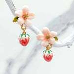 Floral earrings with strawberry details on a white background