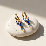 September Sapphire convertible huggie earrings featuring freshwater pearls, blue semi-precious stones and sparkling CZ glass accents.