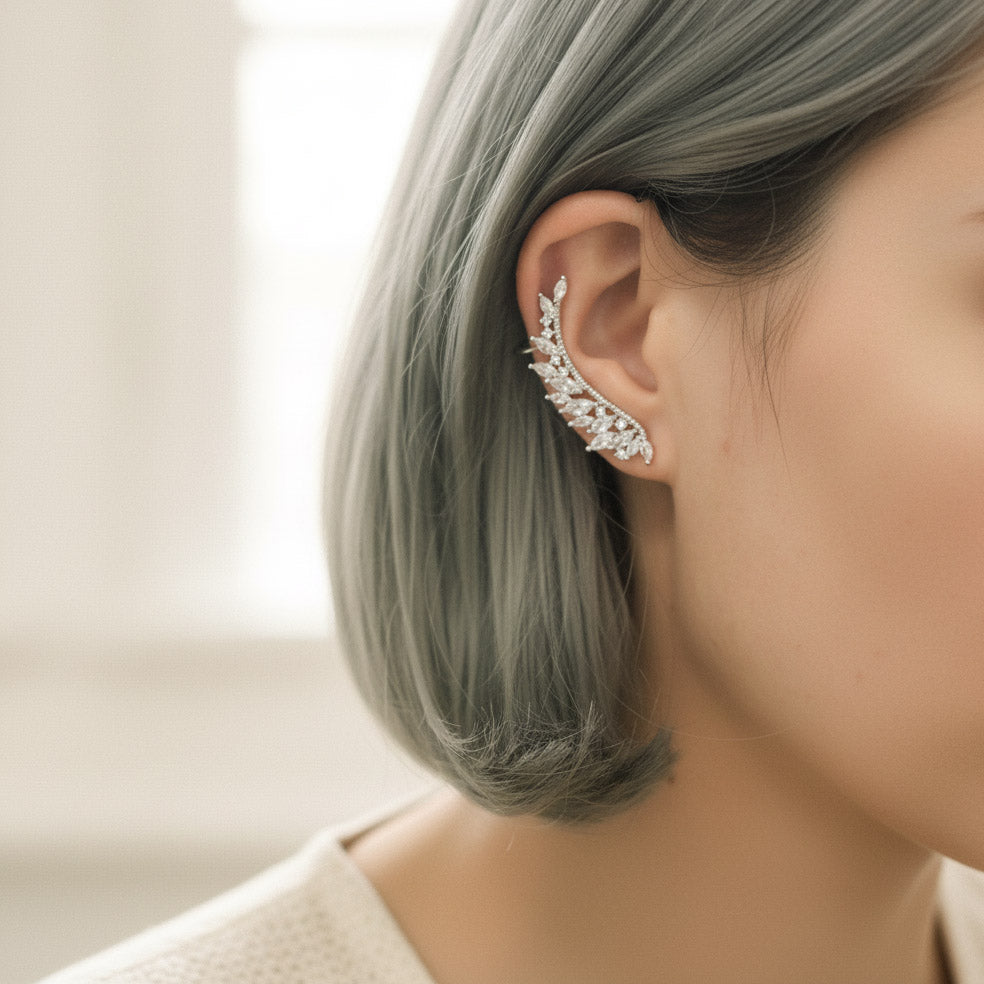 Close-up of a person wearing an elegant ear cuff with intricate detailing.