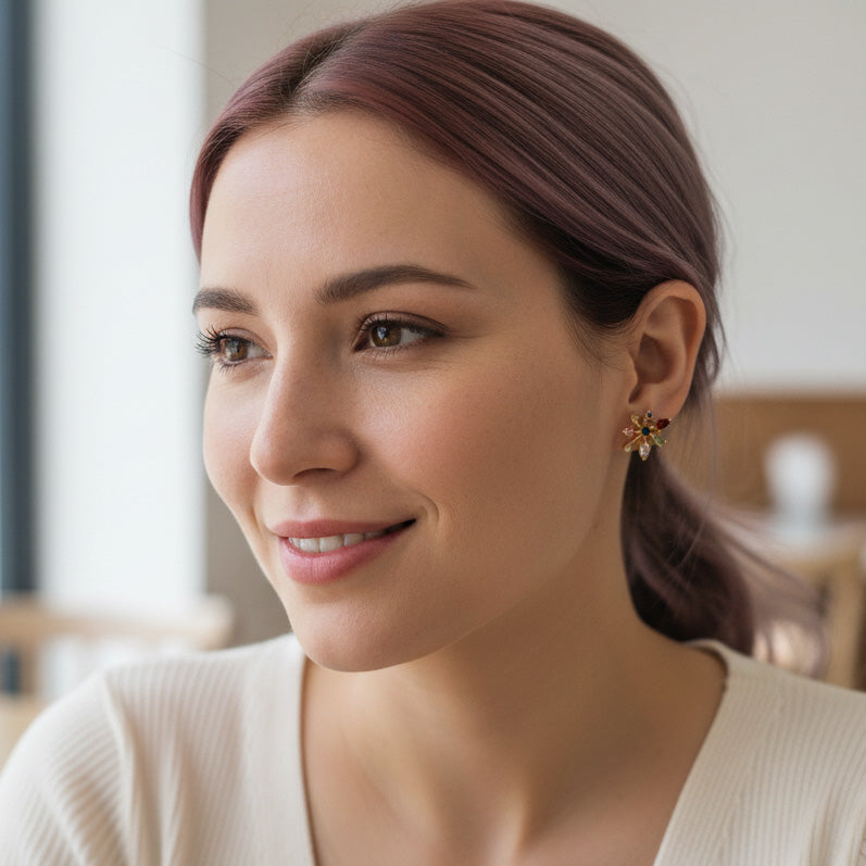 A2K London gold starburst stud earrings with multicolour CZ stones, small geometric sparkle design.