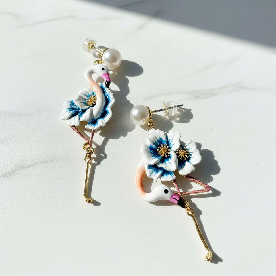 Flamingo-shaped earrings with floral details on a white background