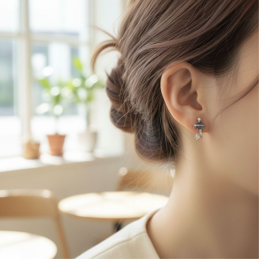 Close-up of a person wearing earrings with a blurred indoor background
