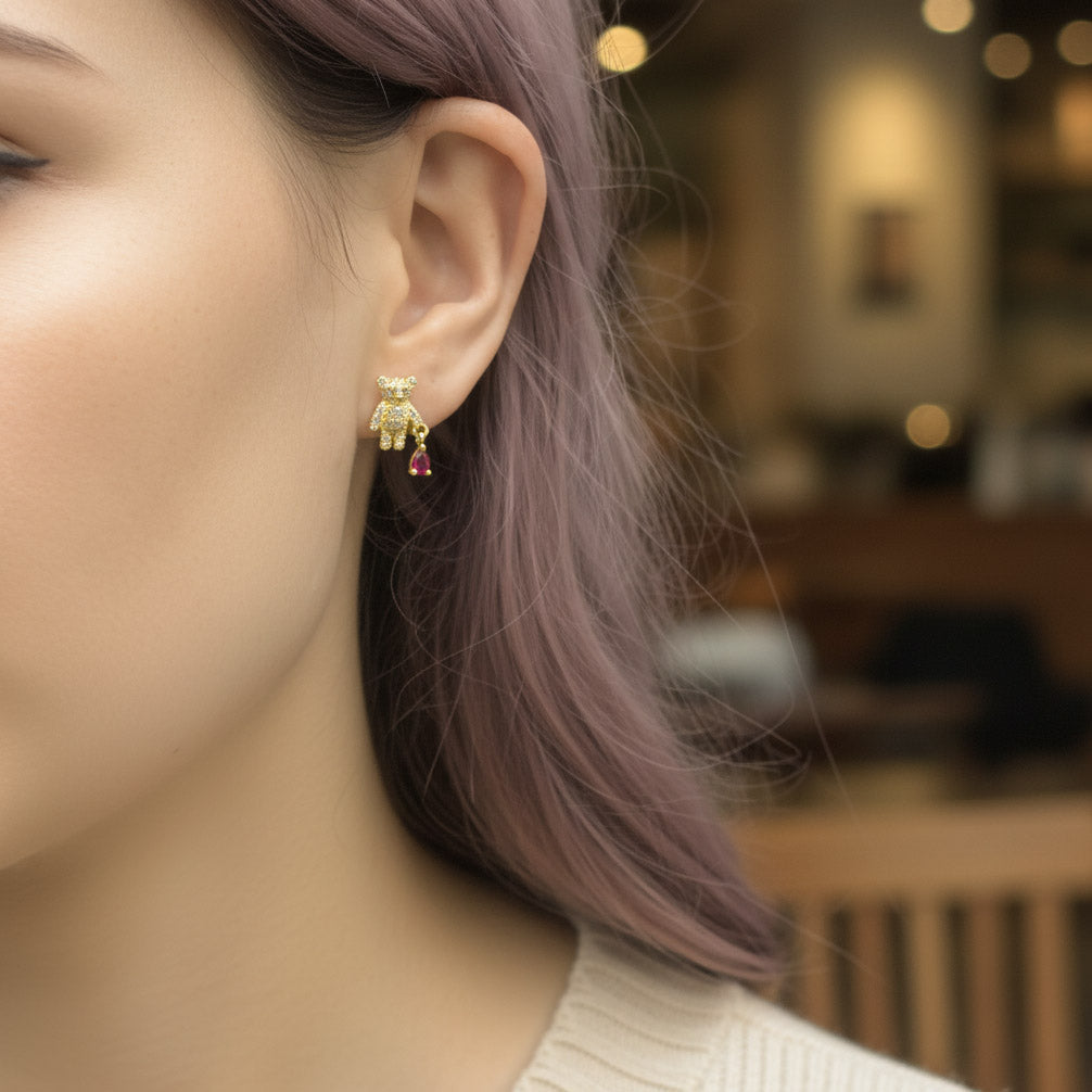 Close-up of a person wearing a green and red earring with a blurred background