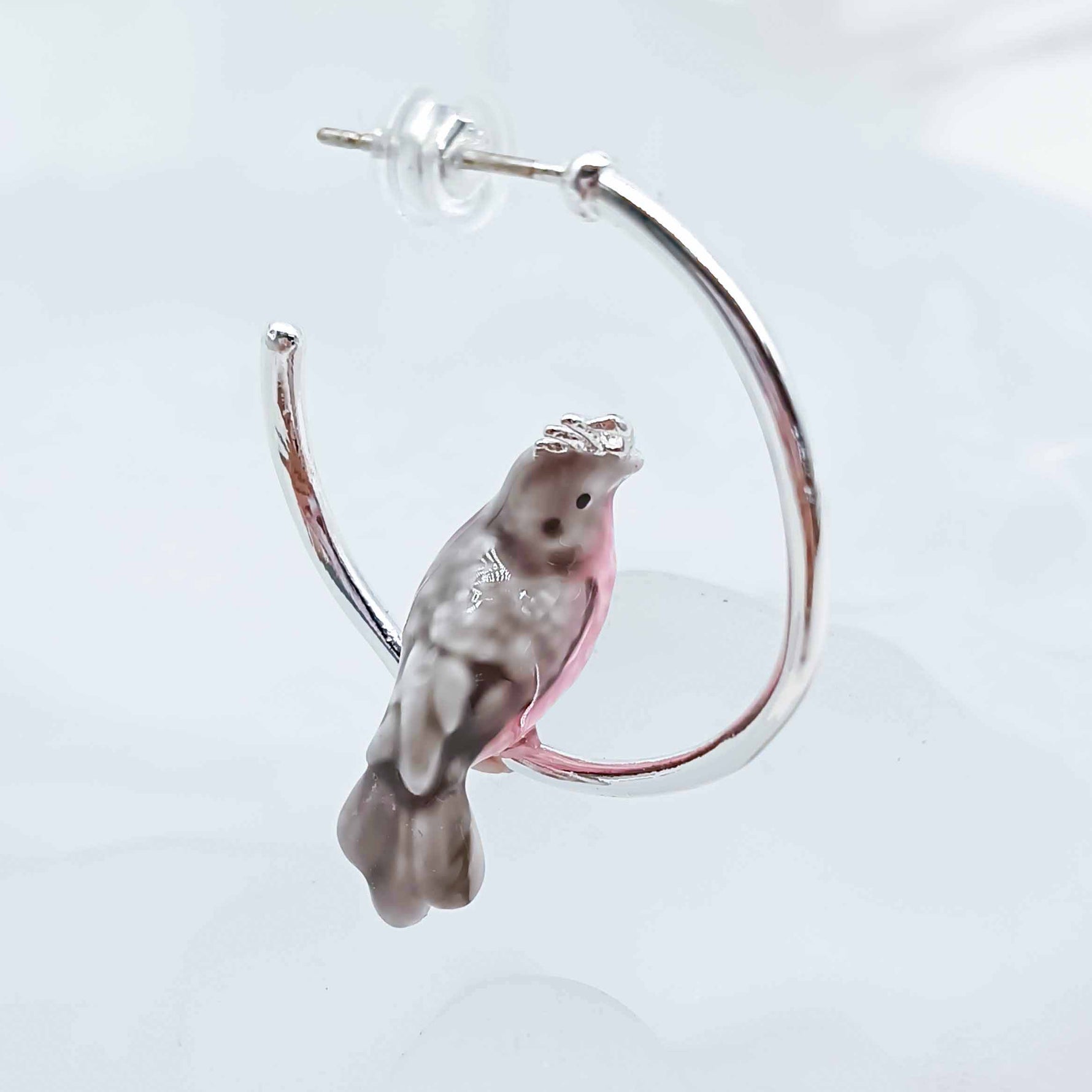 Earring with a bird design on a white background