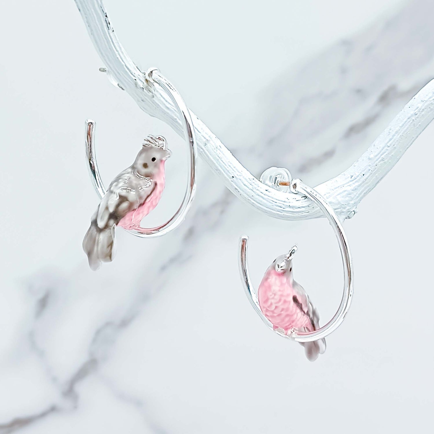 Cockatoo earrings on a marble background