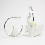 White bird earrings on a white background