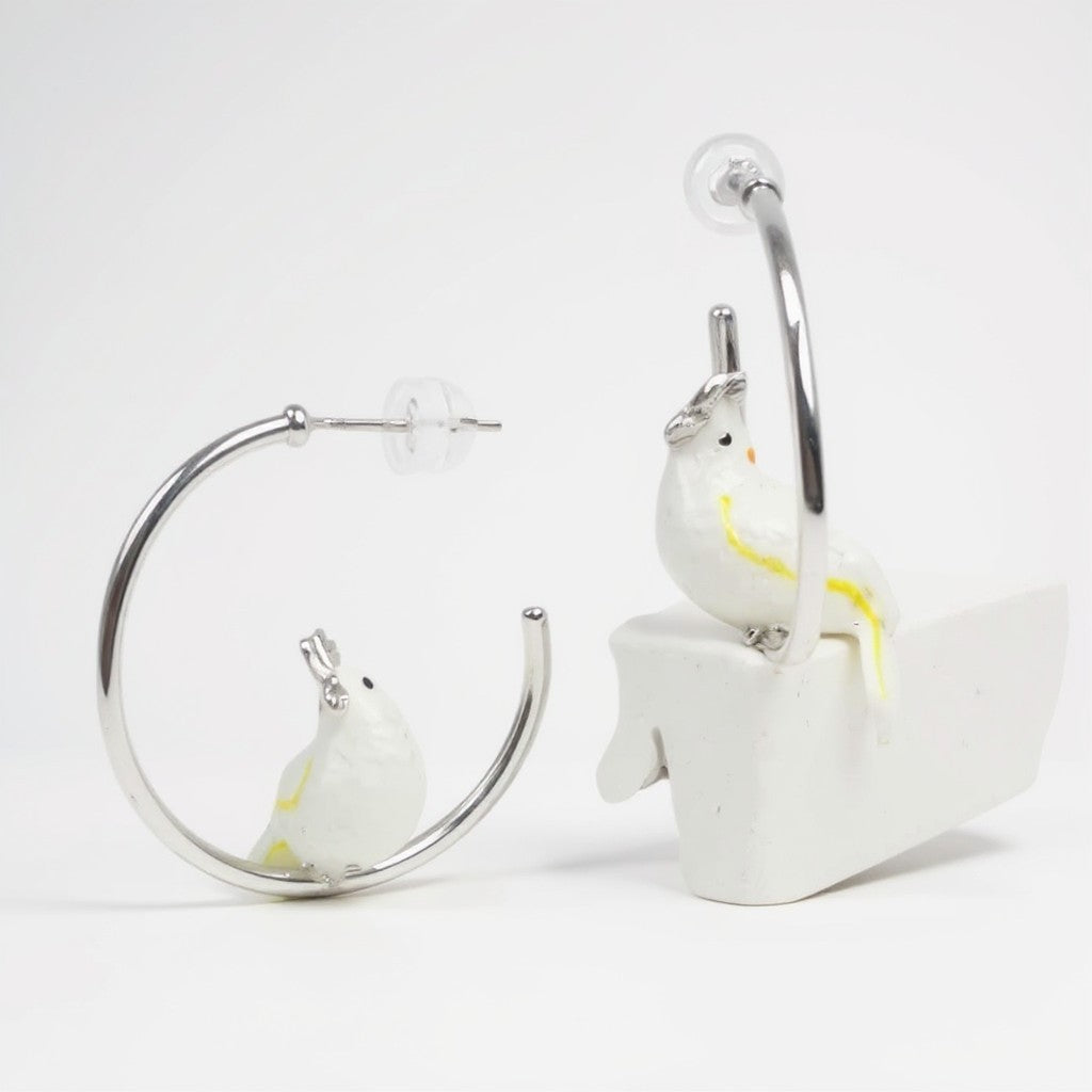 White bird earrings on a white background