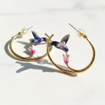 Hoop earrings with hummingbird designs on a white background