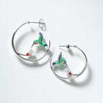 Hoop earrings with hummingbird charms on a white background