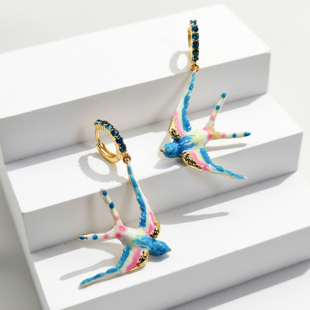 Colorful earrings with gold accents on a white surface