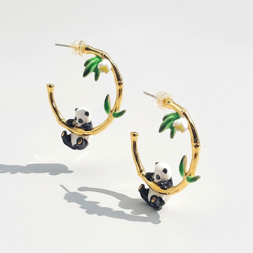 Gold hoop earrings with panda and bamboo design on a white background