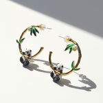 Hoop earrings with panda and bamboo design on a white background