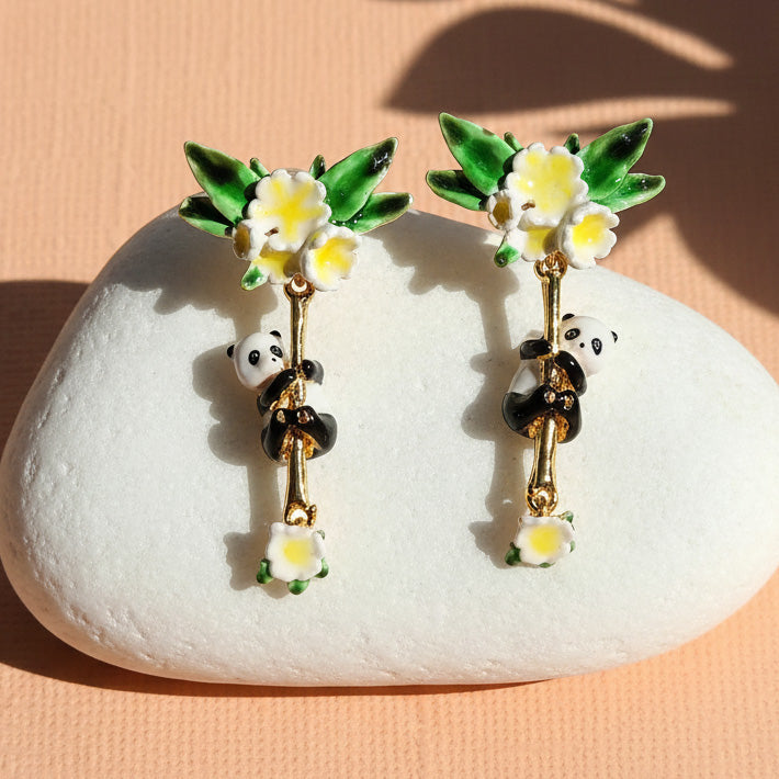 Panda and flower earrings on a white stone with a peach background