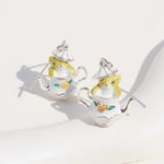 Teapot-shaped earrings with mouse designs on a white background