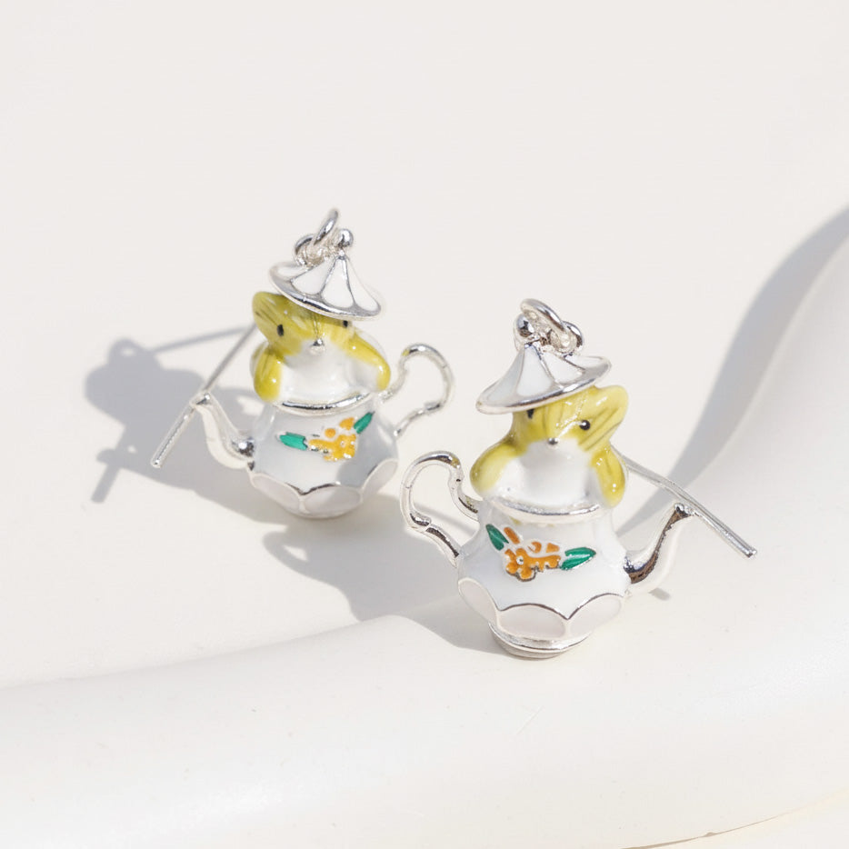 Teapot-shaped earrings with mouse designs on a white background