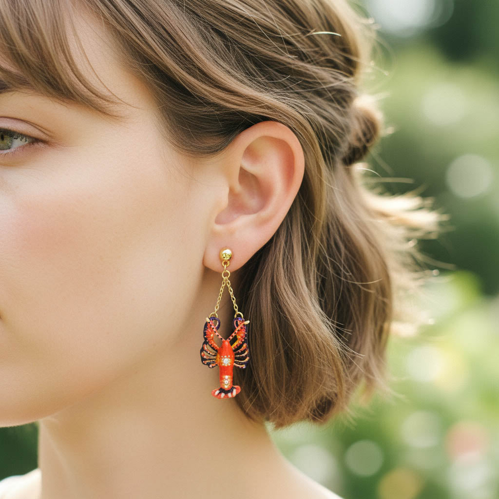Close-up of a person wearing a unique earring with a blurred green background