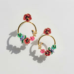 Colorful floral hoop earrings on a light gray background