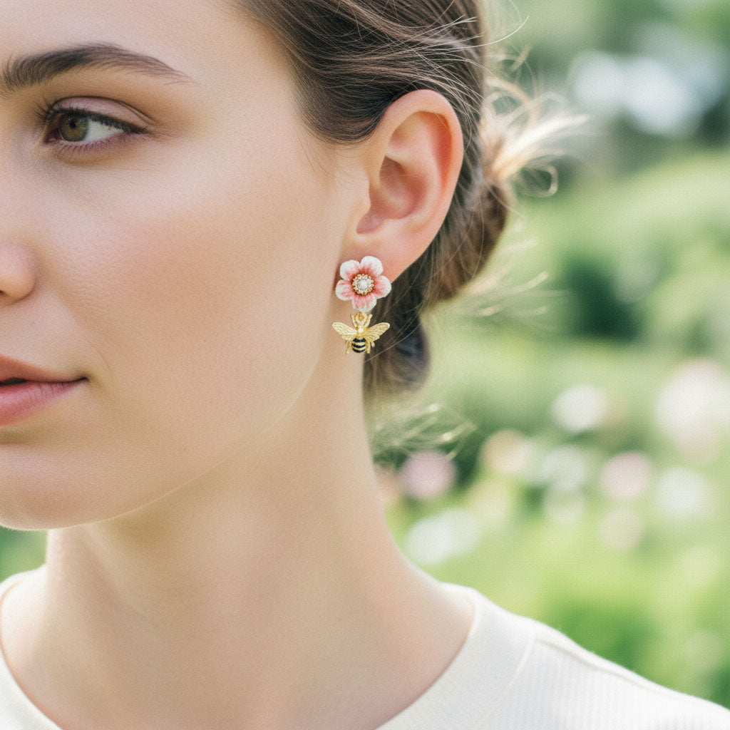 Close-up of a woman wearing floral earrings with a blurred natural background