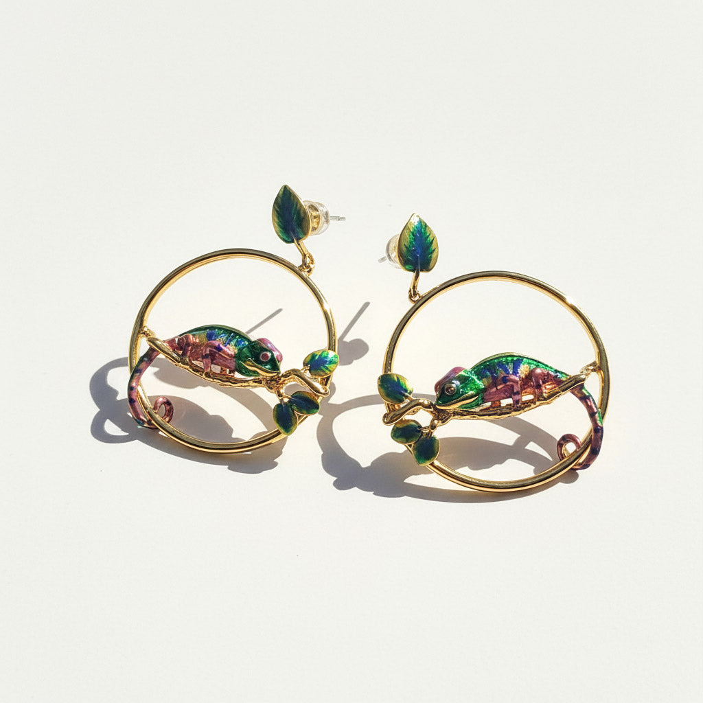 Gold hoop earrings with colorful gemstones on a light background