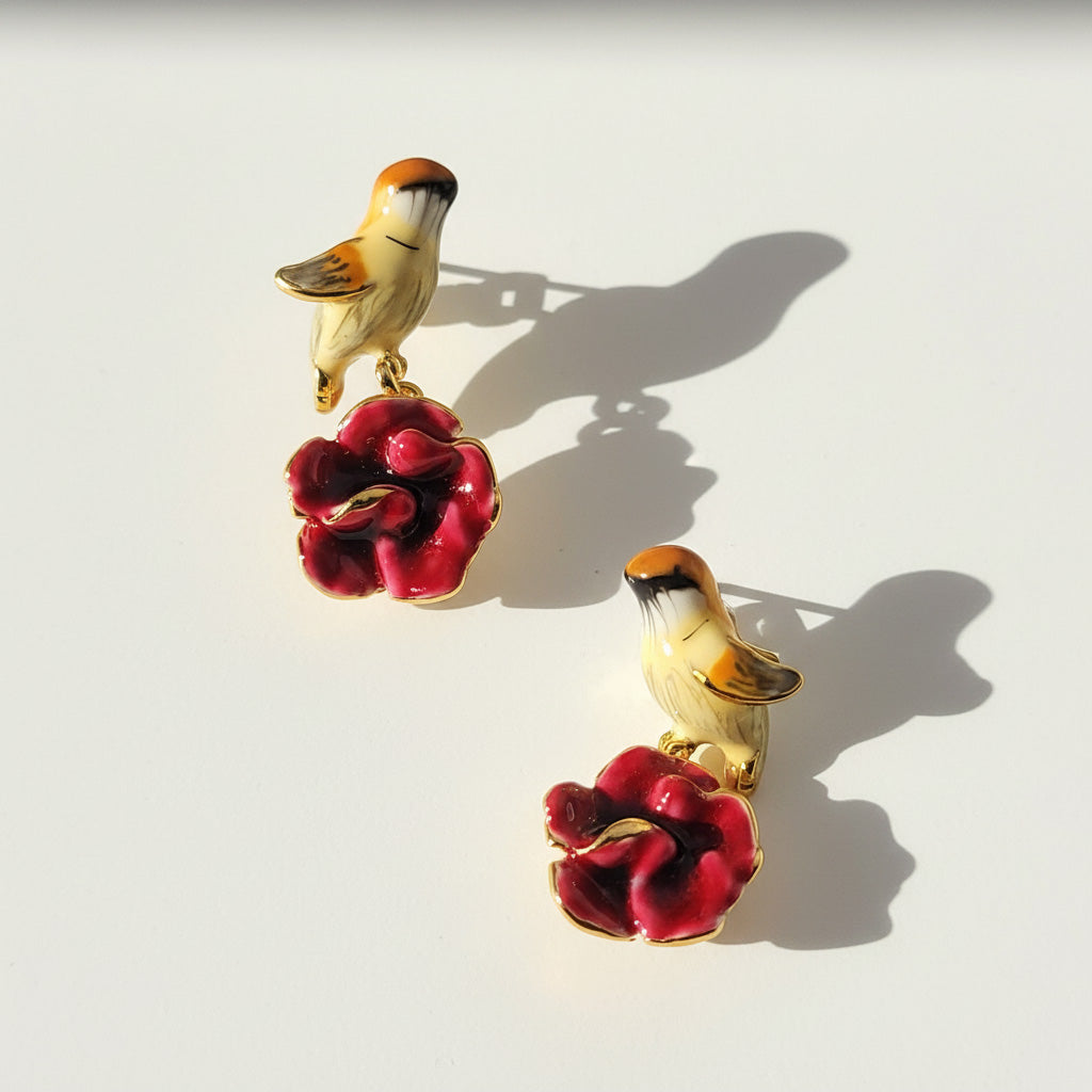 Bird and flower earrings on a light background
