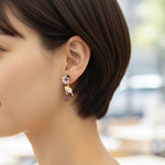 Close-up of a person wearing a floral earring with a blurred background