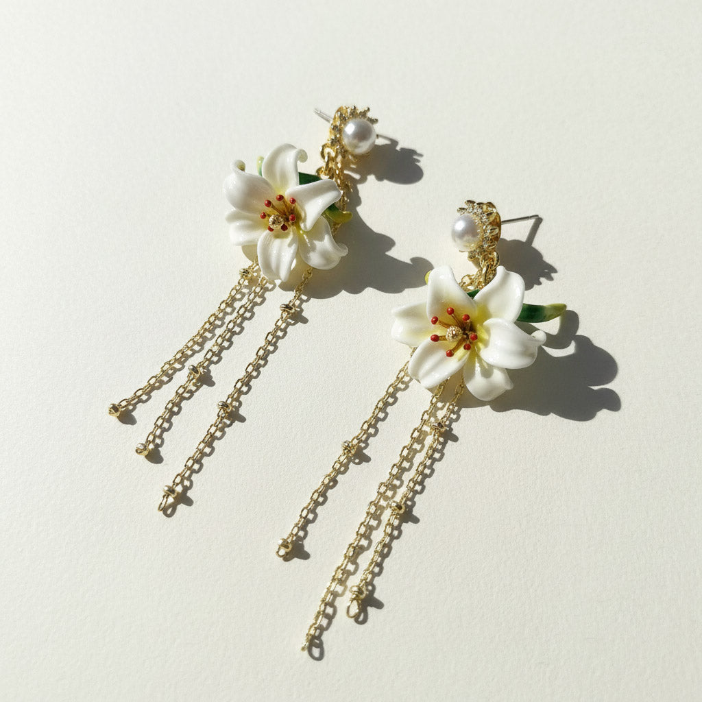 Floral earrings with gold chains on a light background