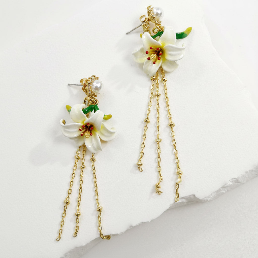 Floral earrings with gold chains on a light background
