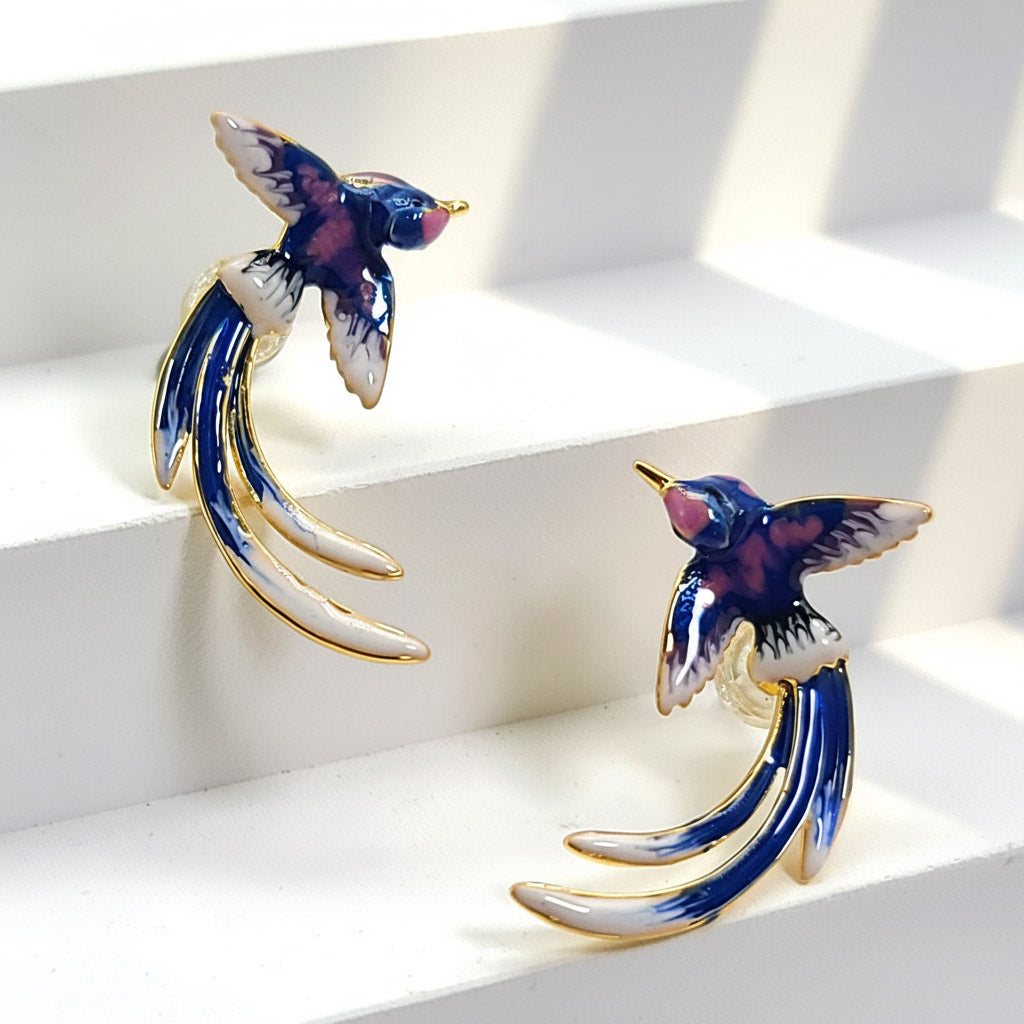 Pair of bird-shaped earrings on a white background
