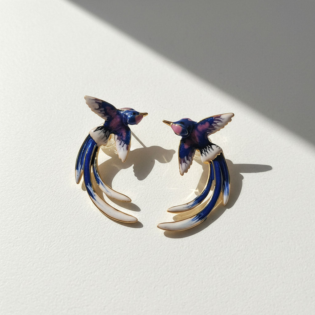 Pair of bird-shaped earrings on a light background
