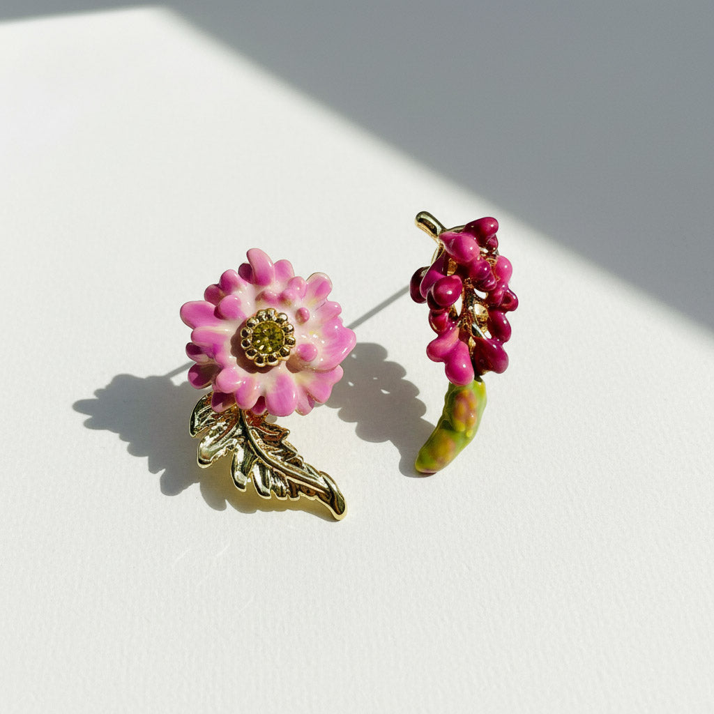 Two floral-themed pins on a white surface with a soft shadow.